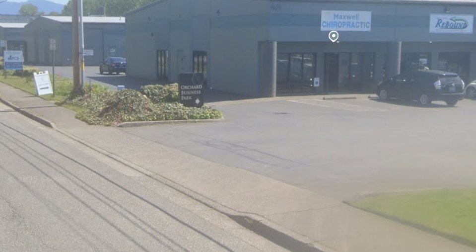 Orchard Business Park sign beside the driveway on W Orchard Drive. Turn into this driveway, then continue to the second building on the right, Suite 2.